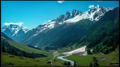 A mountain range with snow-capped peaks, a river flowing through a valley, and green hills.