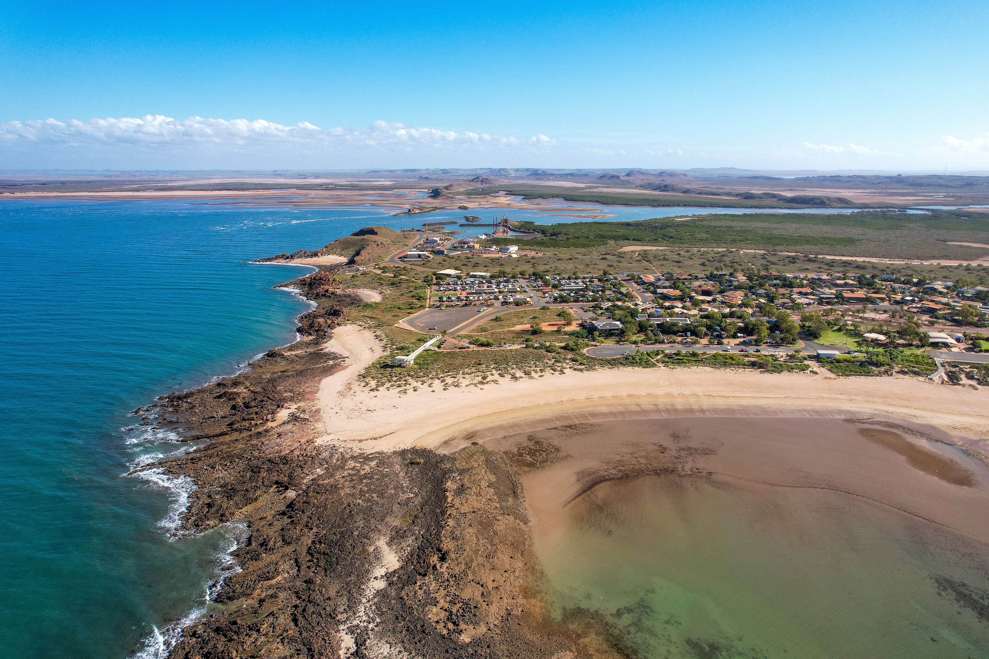 Aerial view of beautiful Honeymoon Cove Beach with sandy shoreline and calm ocean, Point Samson, Australia.