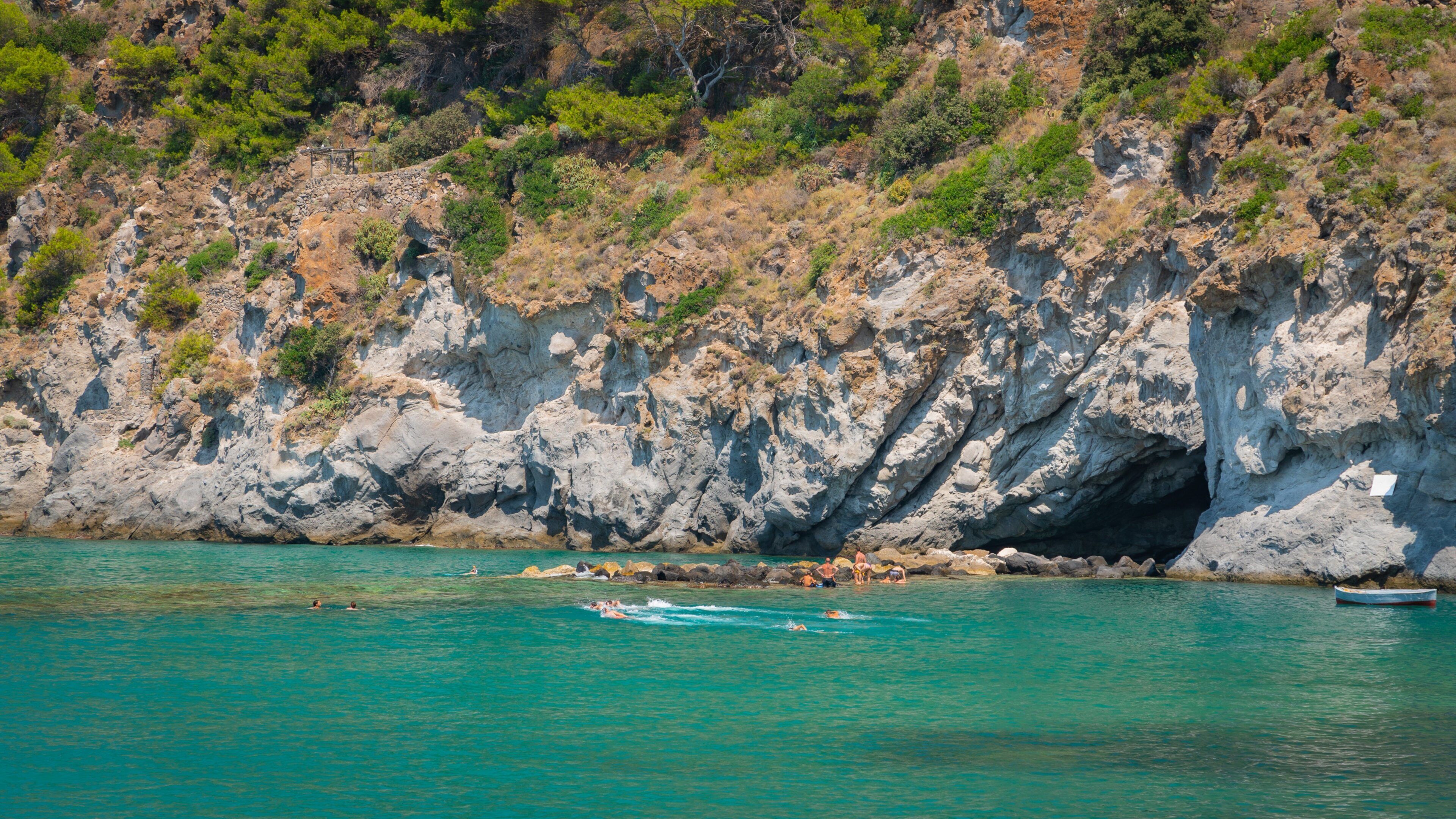 San Francesco Beach which includes rugged coastline, swimming and general coastal views