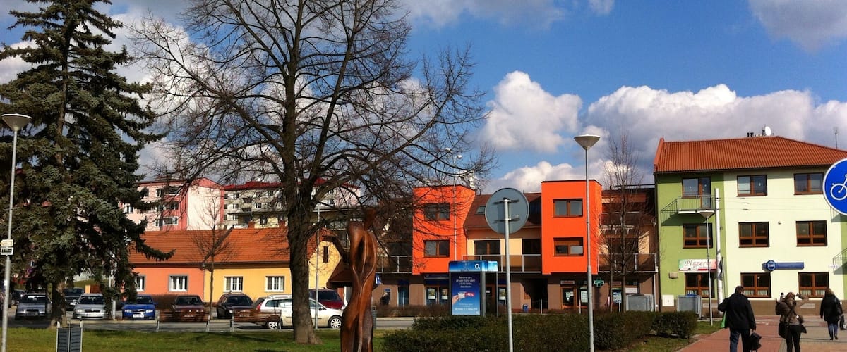 A city street with colorful buildings, a bicycle lane, and pedestrians.