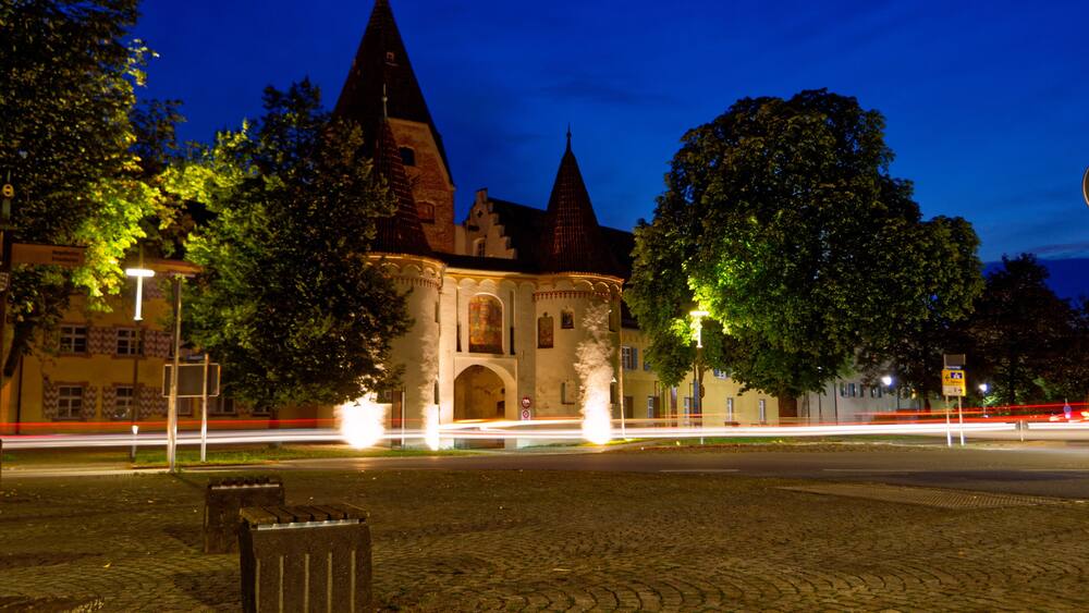 Old castle-like building and fountains with backlights in Weissenhorn, Bavaria, Germany