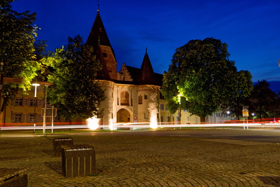 Old castle-like building and fountains with backlights in Weissenhorn, Bavaria, Germany