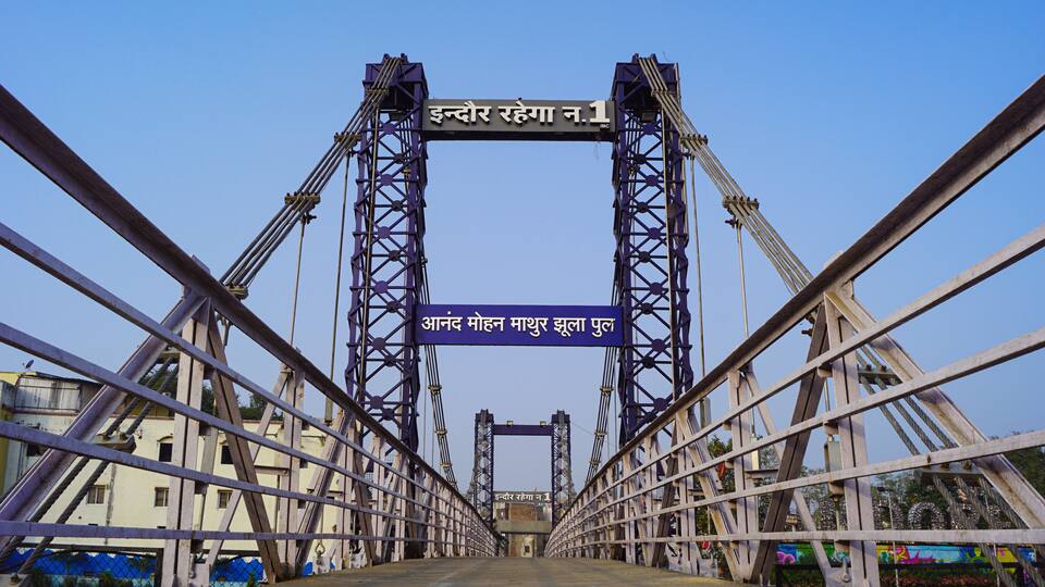 A bridge with two towers and a sign in Hindi.