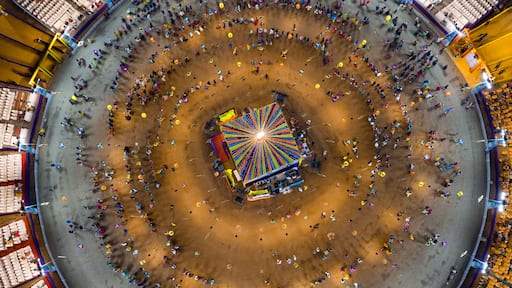 People dance at hindu Navratri festival the traditional Garba dance wearing indian clothes. Spectacular Top down aerial view of indian religious festival