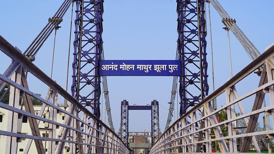 A bridge with blue and white structural elements and Hindi text.