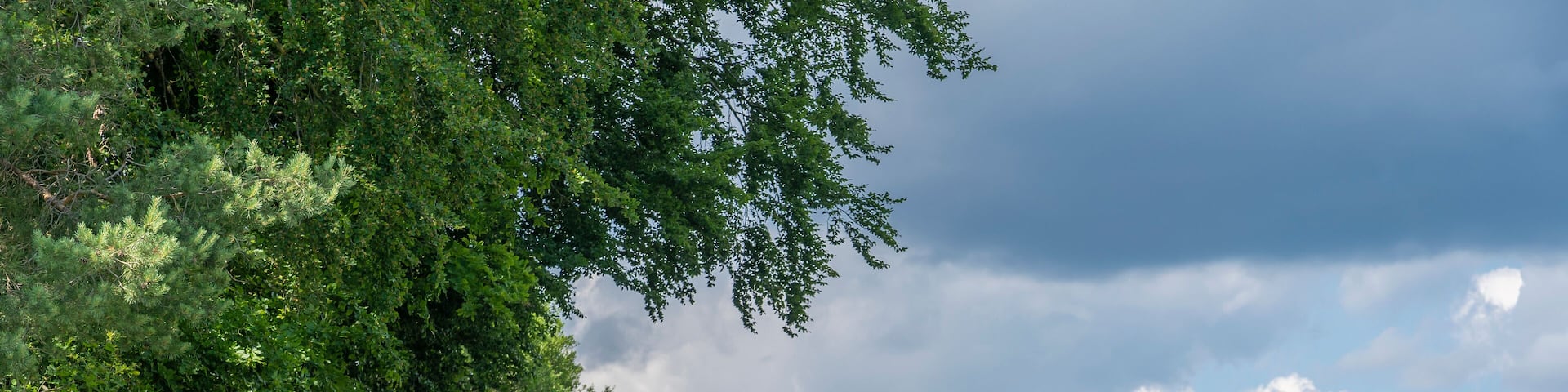 grandmother and granddaughter riding their mountain bikes in front of the awesome skyline of Hiltpoltstein in Frankonian Switzerland, Bavaria, Germany