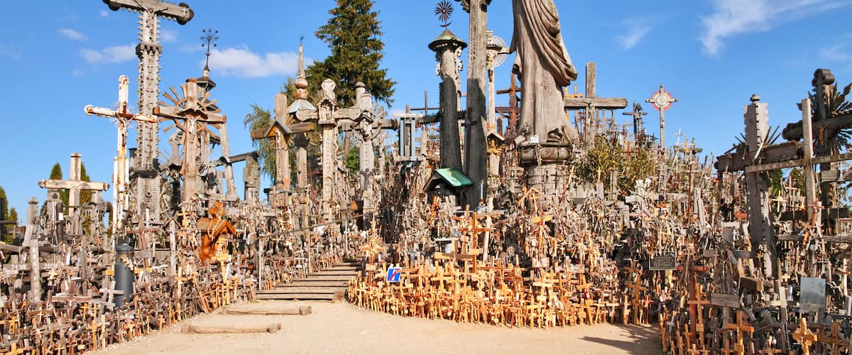 A cemetery with numerous crosses and statues.