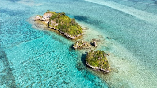 Aerial view of tropical island Yojima with crystal clear turquoise water and serene beaches, Kunigami District, Japan.
