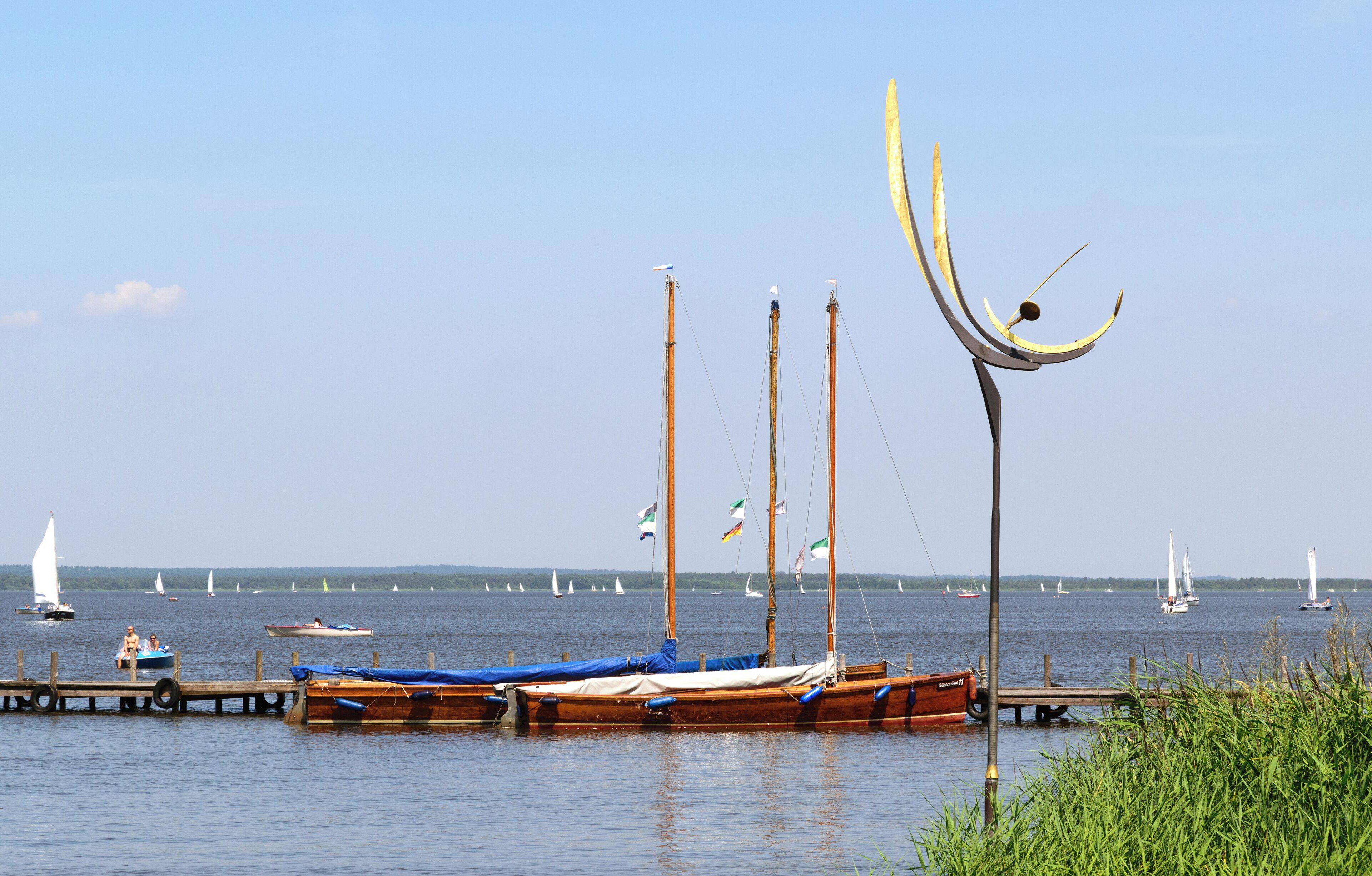 Boats and sculpture "Dance of the Winds" at Lake Steinhude