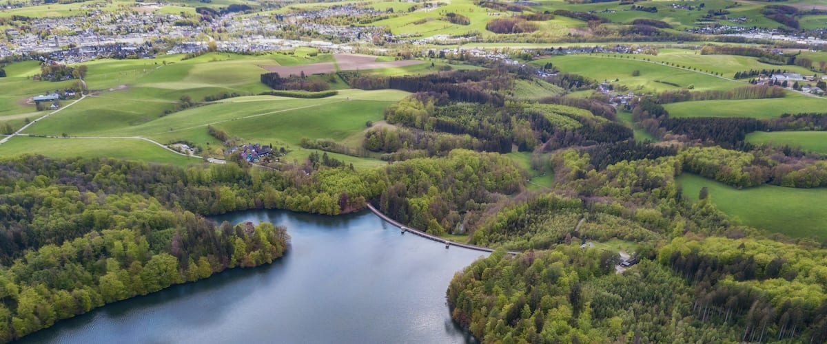 Aerial view of the Neyetalsperre (Neye Dam) in the Bergisches Land with a view of Wipperfuerth in the background.