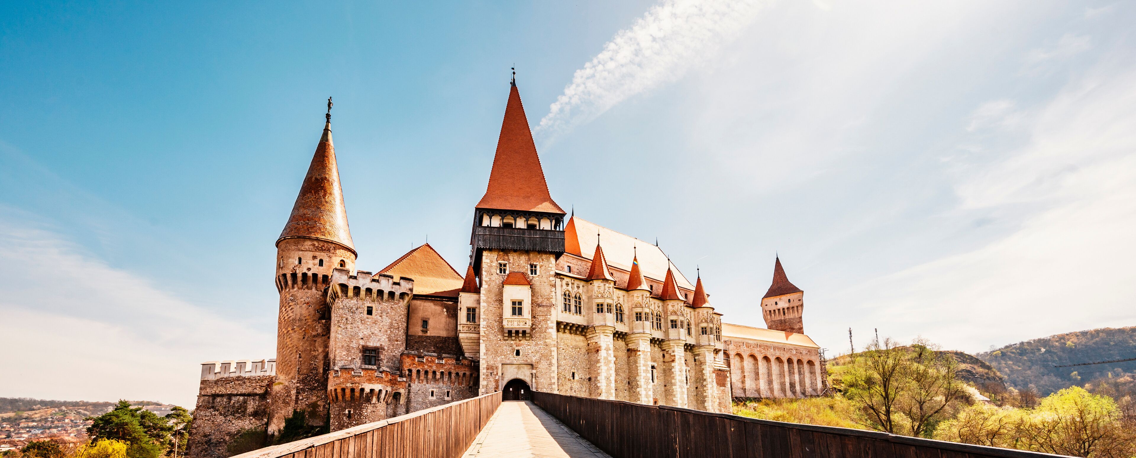 A historic castle with multiple towers and a bridge leading to it.
