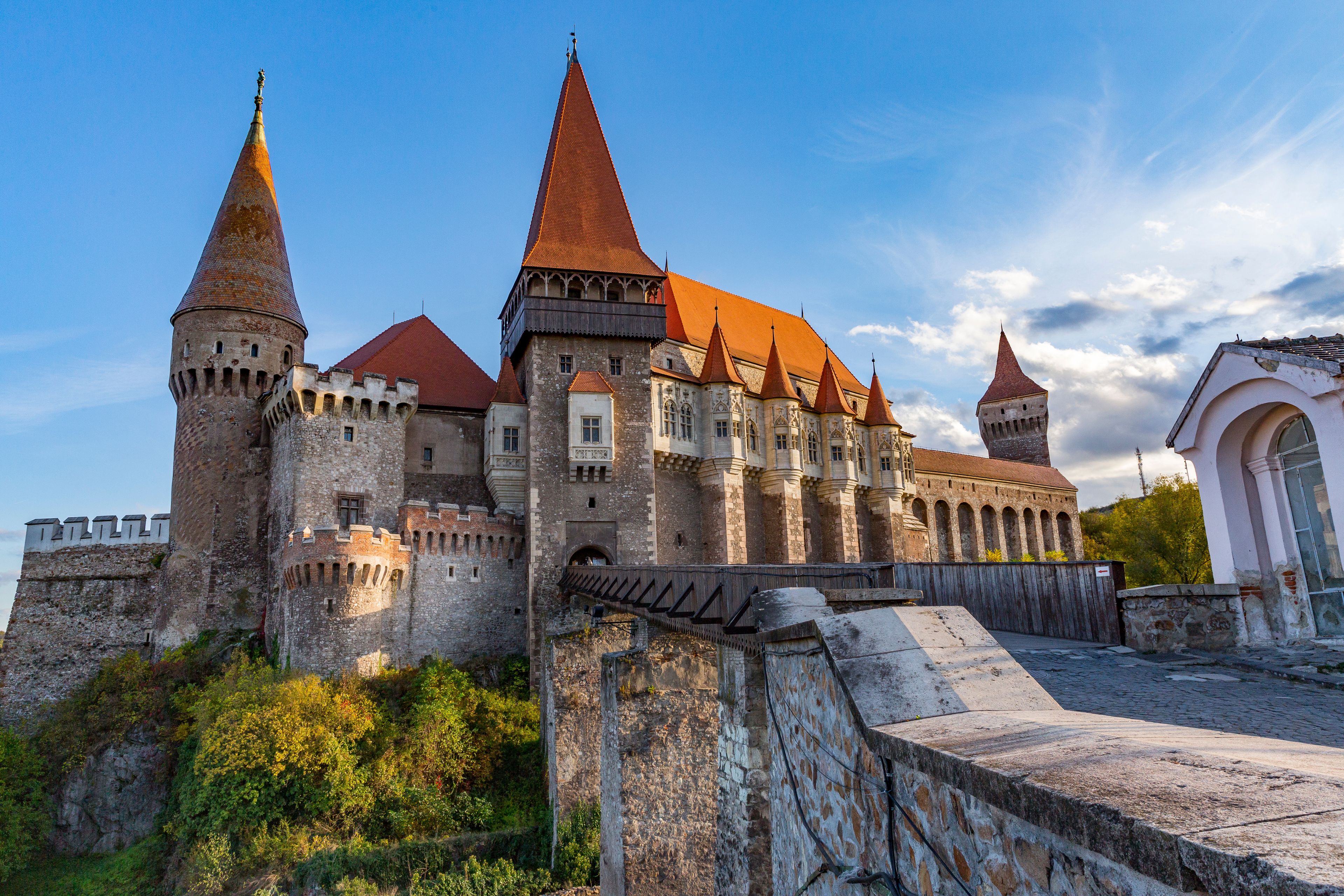 A historic castle with multiple towers and a red-tiled roof.