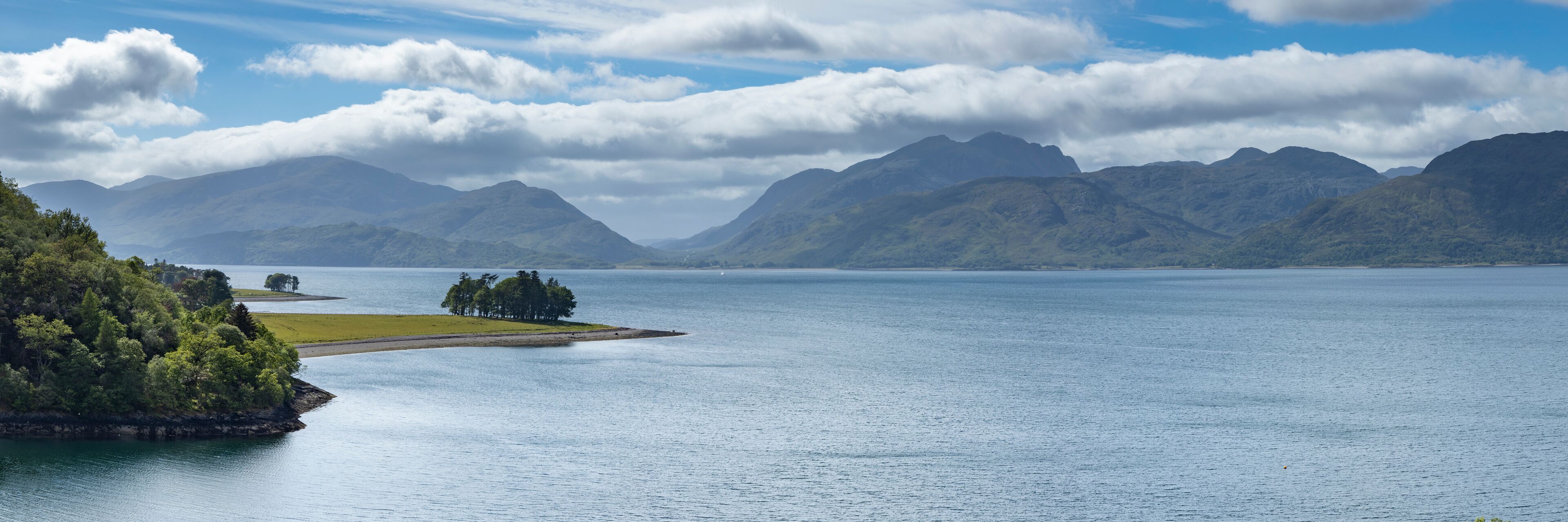 panoramic view of kentallen bay with loch linnhe and the ardnamurchan peninsula in the argyll region of the highlands of scotland on a blue spring day