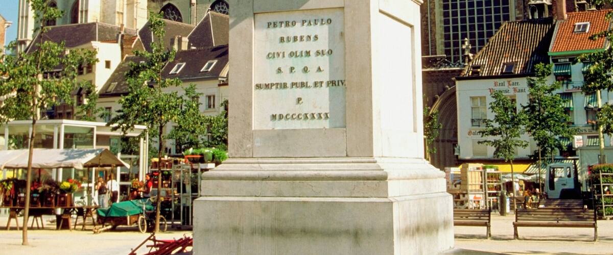 Low angle view of Peter Paul Rubens statue in front of buildings, Cathedral of Our Lady, Antwerp, Belgium