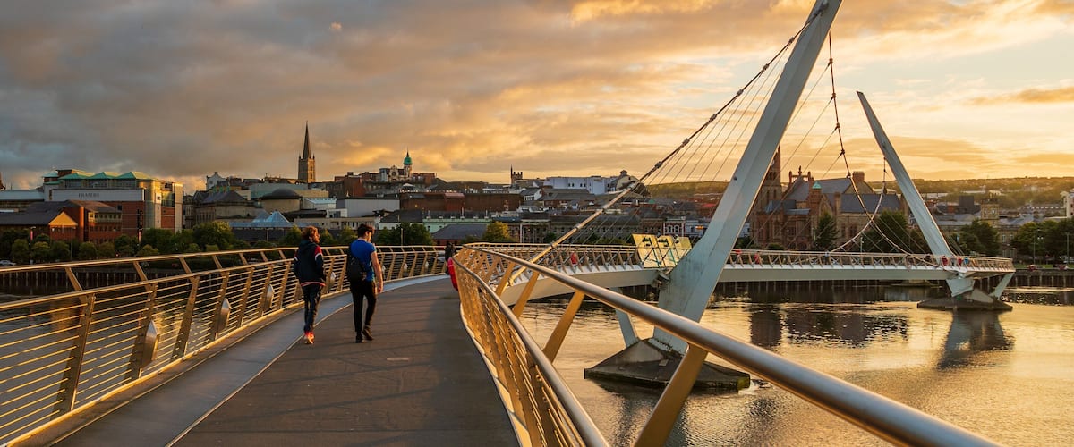 Peace Bridge featuring a river or creek, a bridge and a sunset