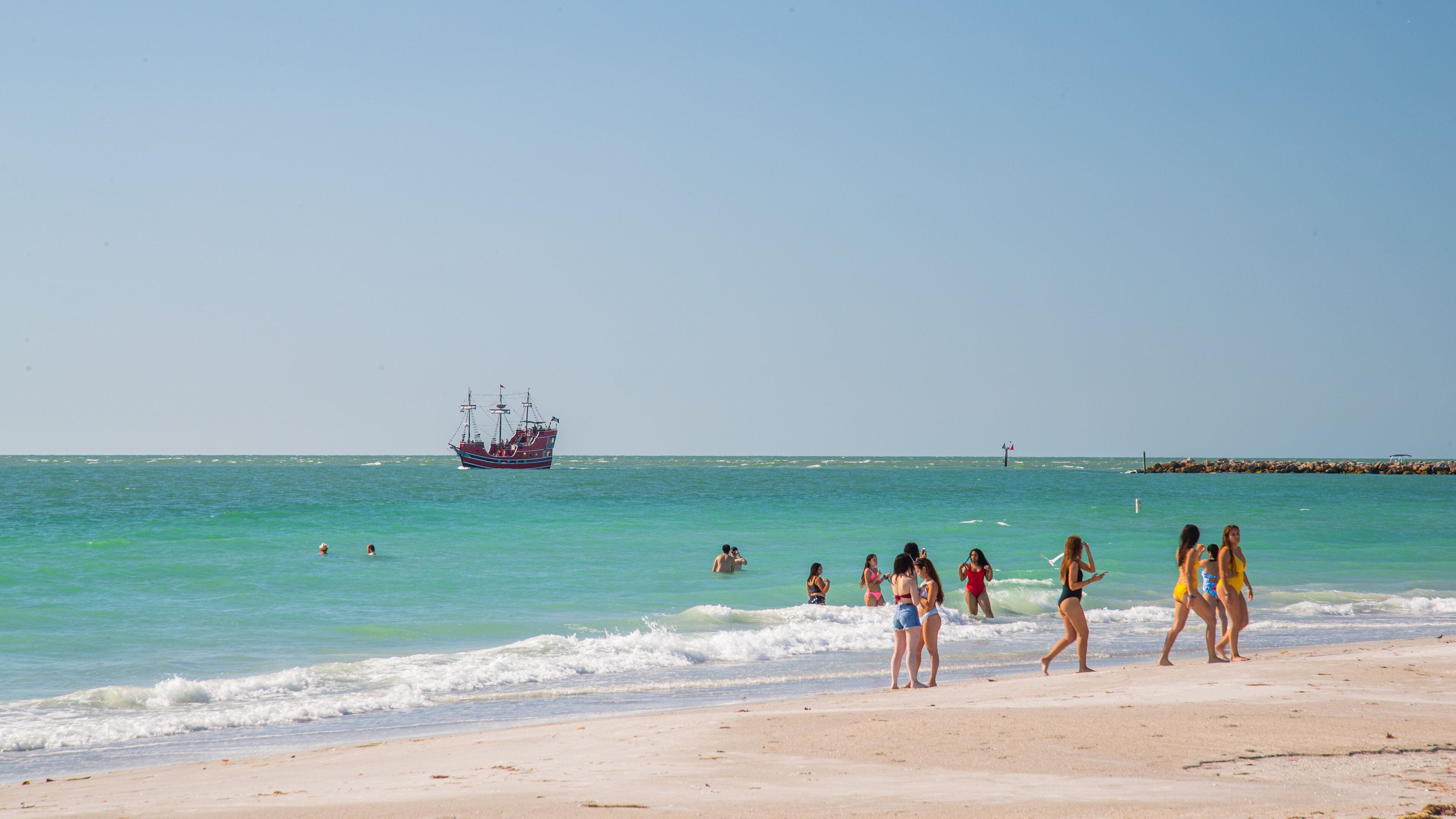 Sand Key Park which includes general coastal views and a beach as well as a small group of people