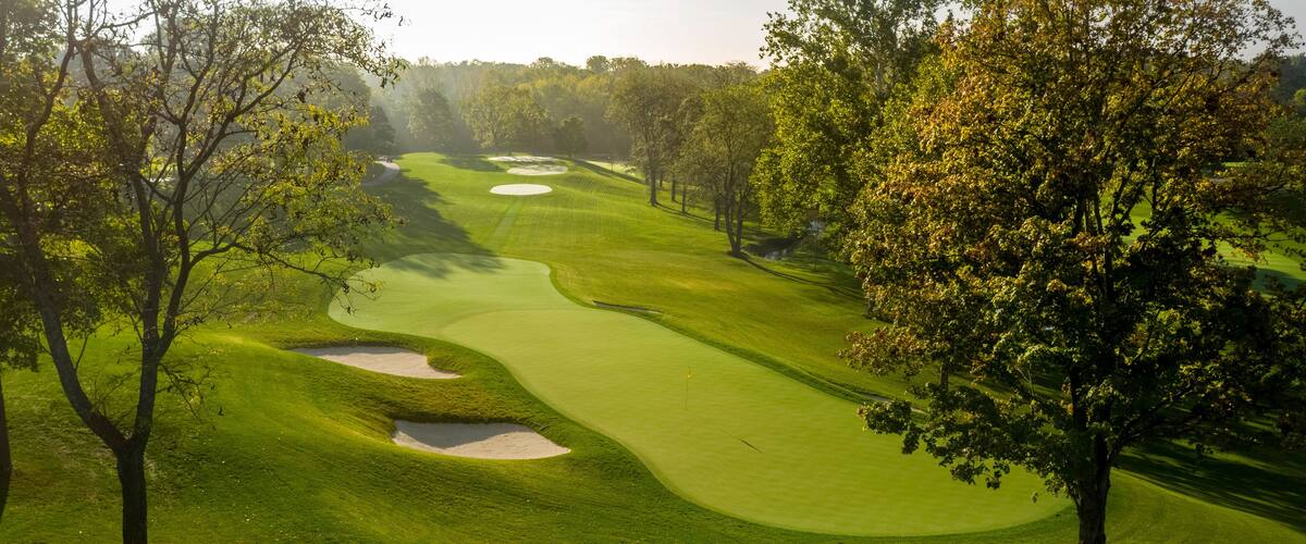 Aerial golf course images of scenic golf holes.