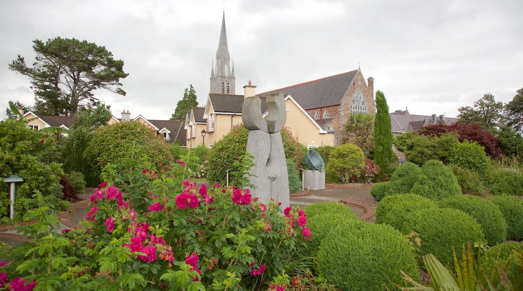 Tralee Town Park showing a statue or sculpture, flowers and a park