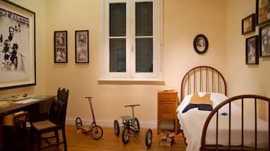 A child's bedroom with a bed, a desk, a chair, and a bicycle.