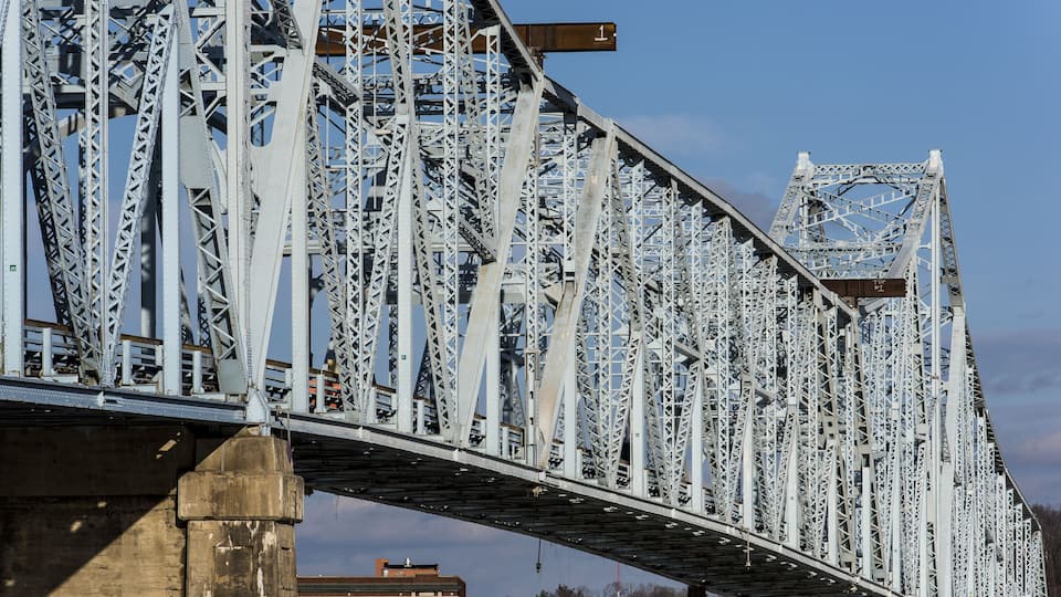 A steel bridge with a clock tower.
