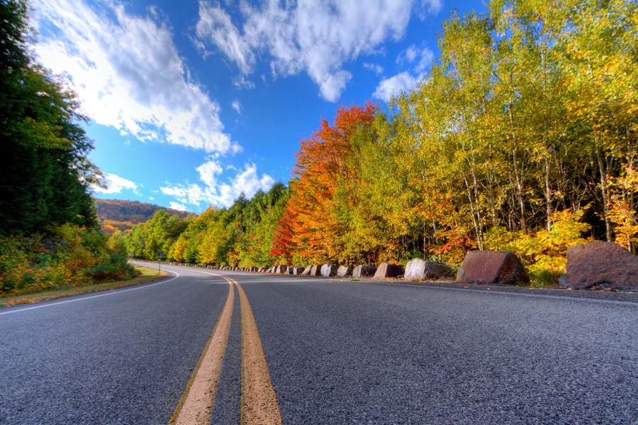 Autumn daytime view of a mountain road in Lake George, NY on Prospect Mountain, Adirondack State Park, with trees changing color.