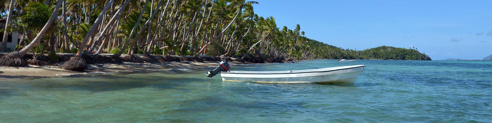 White fishing boat on a tropical island in Fiji