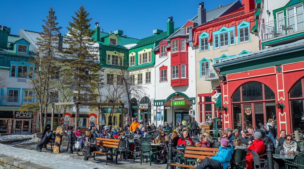 Mont-Tremblant Pedestrian Village showing outdoor eating and street scenes as well as a large group of people