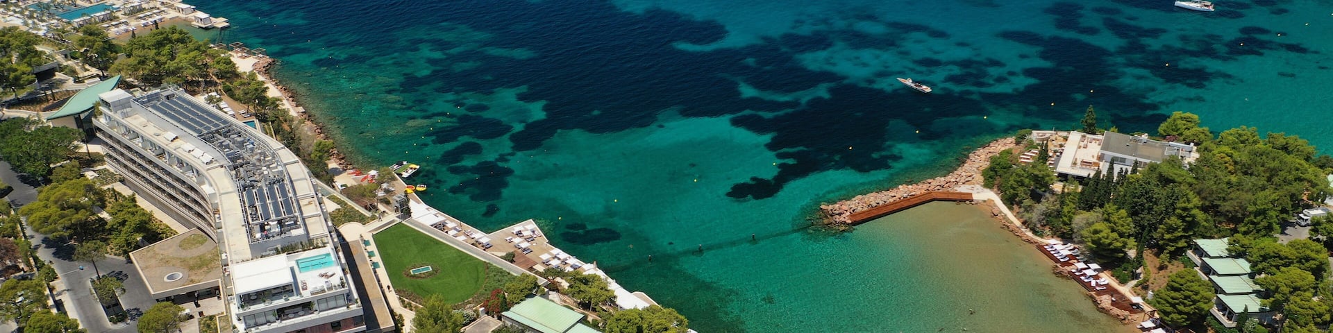 Aerial drone photo of rocky seascape in Vouliagmeni peninsula, Athens riviera, Attica, Greece