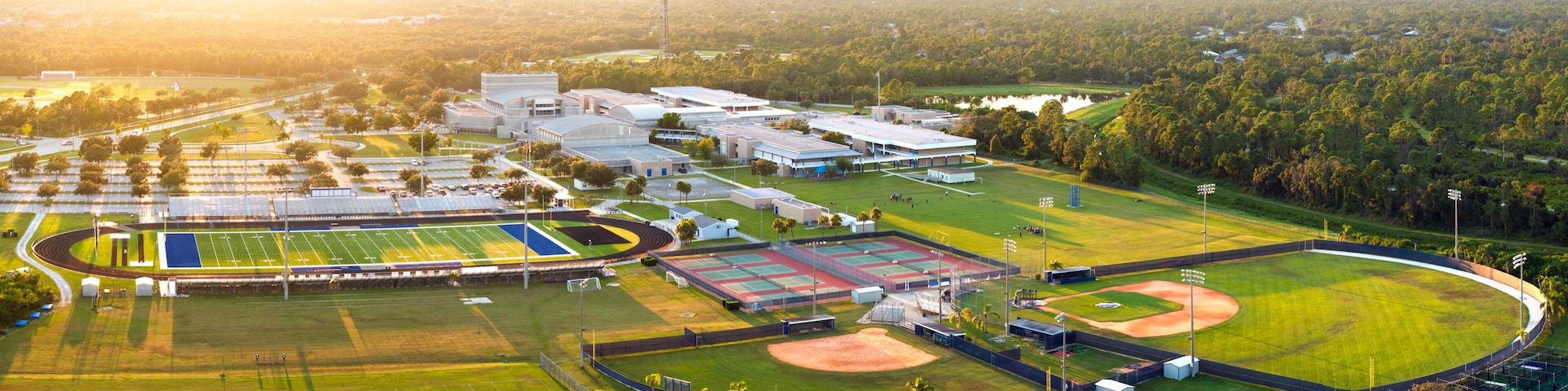 Public high school open air sports facilities in North Port, Florida. American football stadium, tennis courts and baseball diamond sport infrastructure