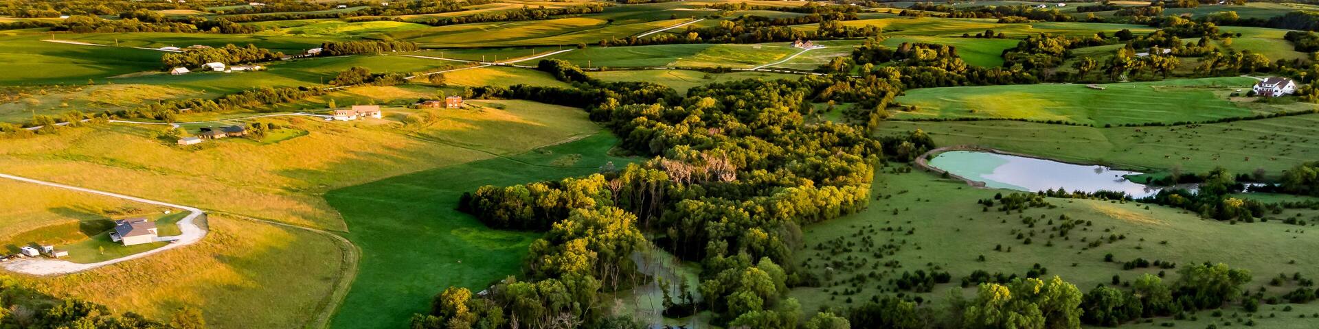 Sunrise over rural Nebraska wetland and stock pond