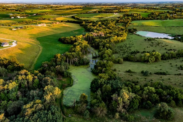 Sunrise over rural Nebraska wetland and stock pond