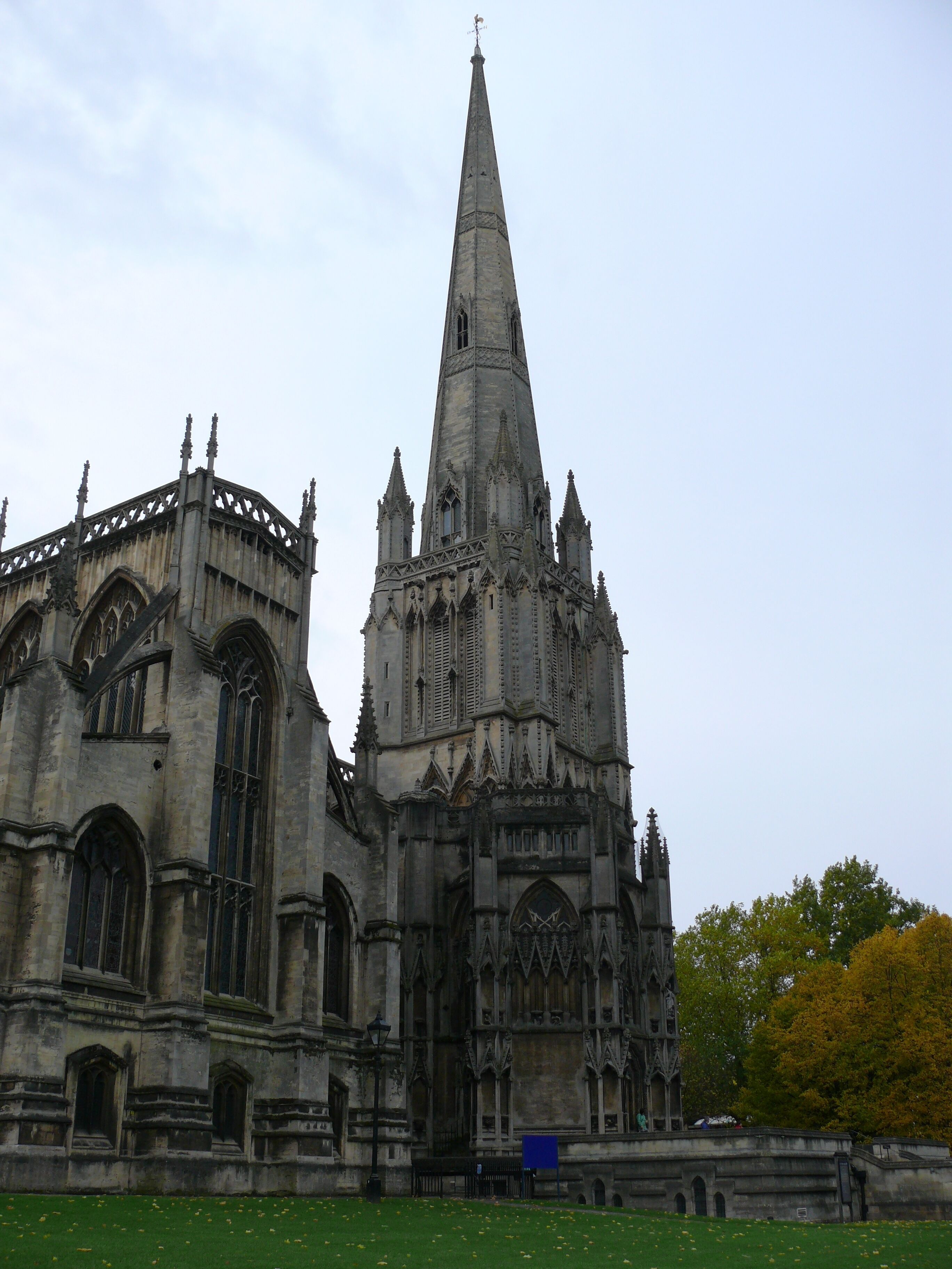 A large Gothic cathedral with a tall spire and intricate stone carvings.