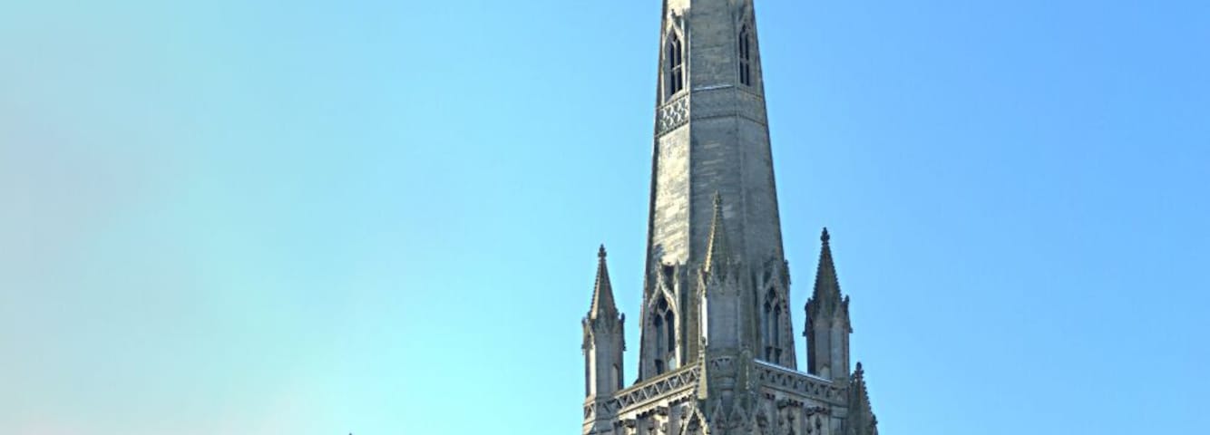 A Gothic cathedral with a tall spire and intricate stonework.