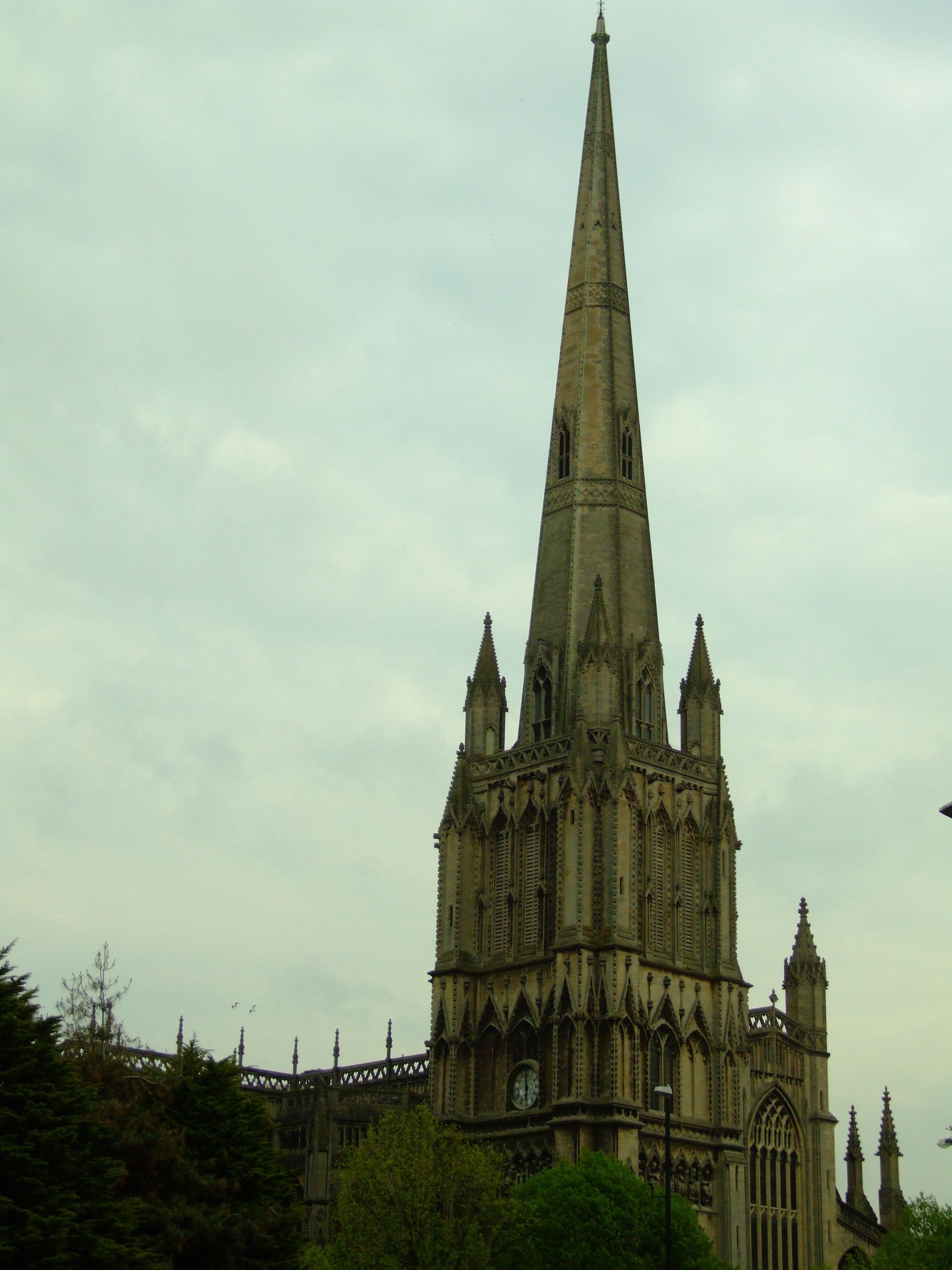 A large Gothic cathedral with a tall spire and intricate stonework.