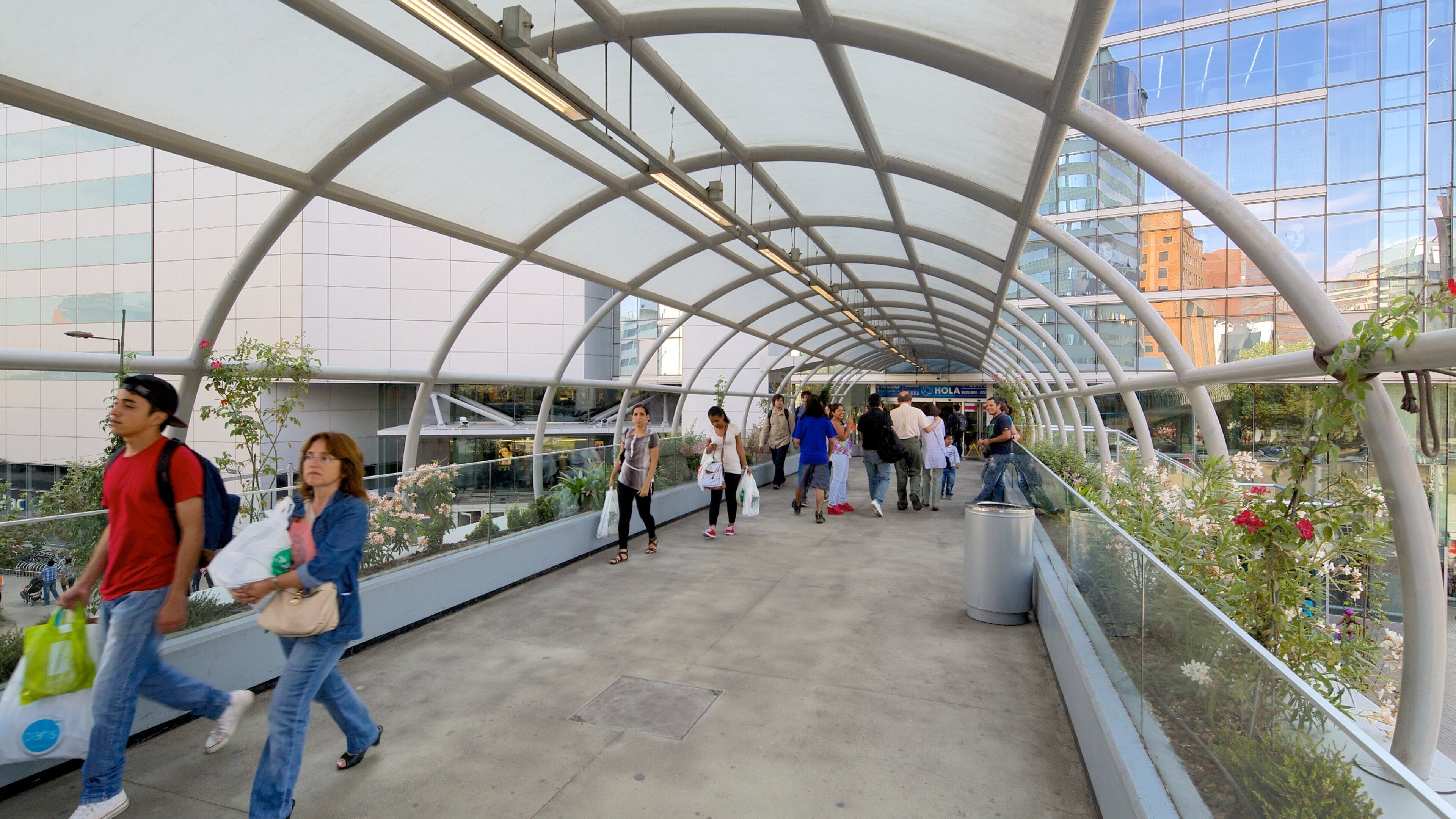 Costanera Center showing a city and a bridge as well as a large group of people