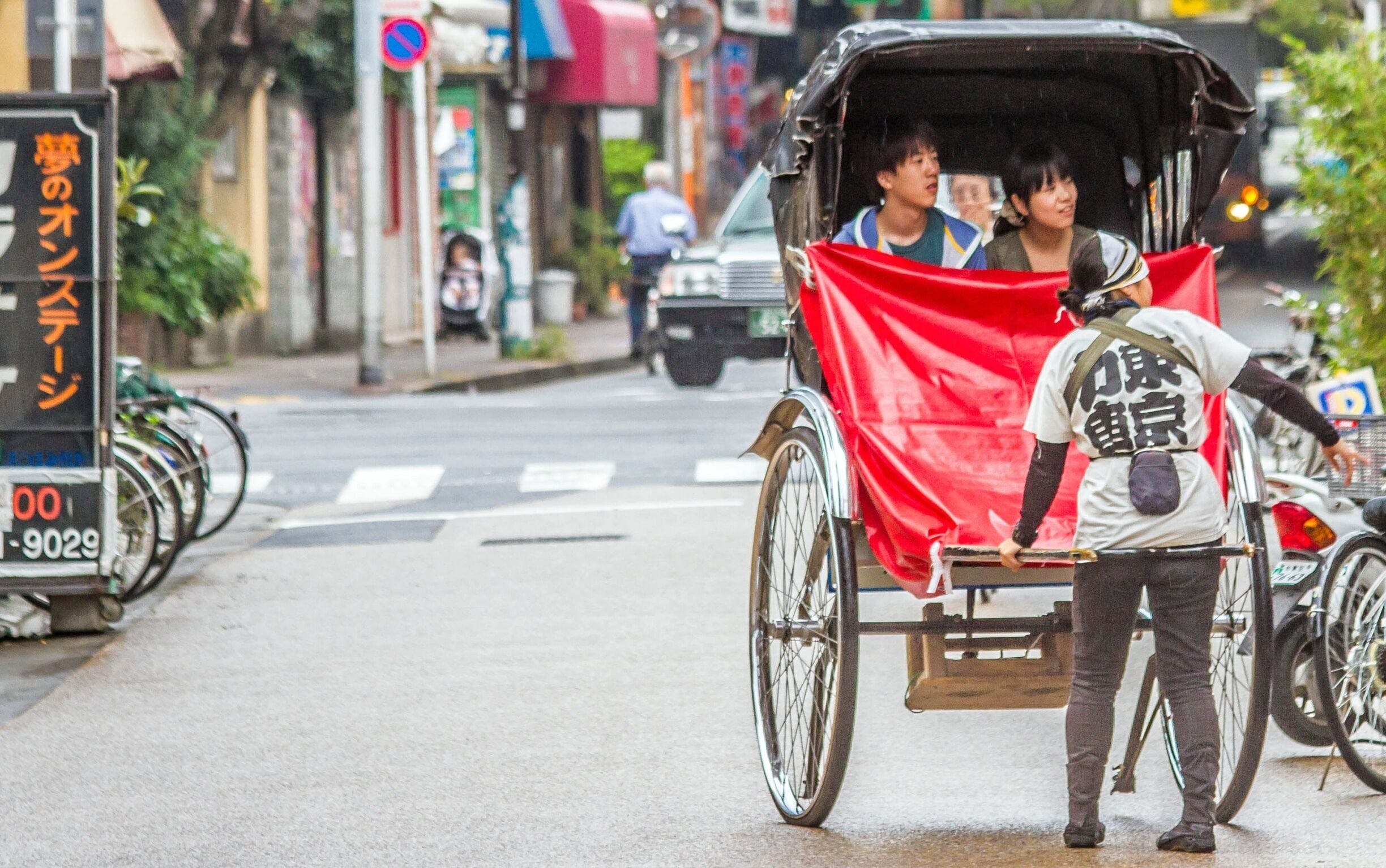 The rickshaw as we know it was invented in Japan in the late 19th century during the modernizing Meiji Period. People power was seen as a cheap, convenient mode of city transport in those pre-taxi days. From Japan, they spread across Asia and all the way to Africa. 

Many countries eventually banned the use of rickshaws as inhumane. 