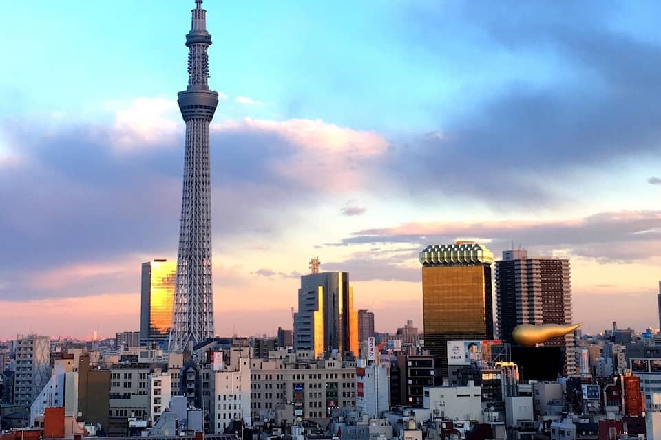 A cityscape with a prominent tower and various buildings.