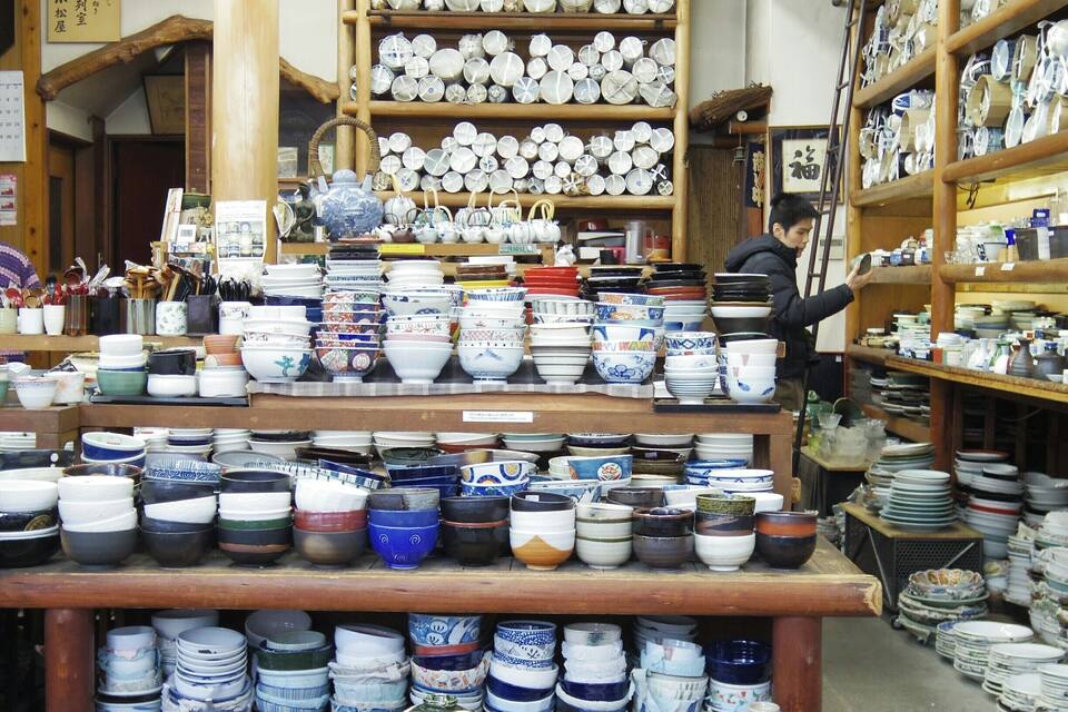 A store with shelves full of various bowls and plates.