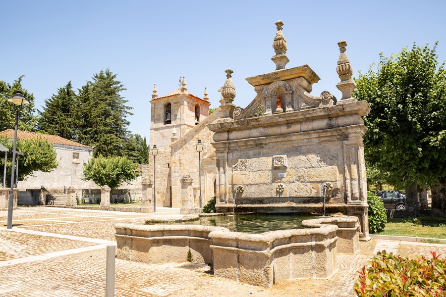 Saint Francis water fountain and the Parish church in Vila da Rua town, municipality of Moimenta da Beira, district of Viseu, Portugal
