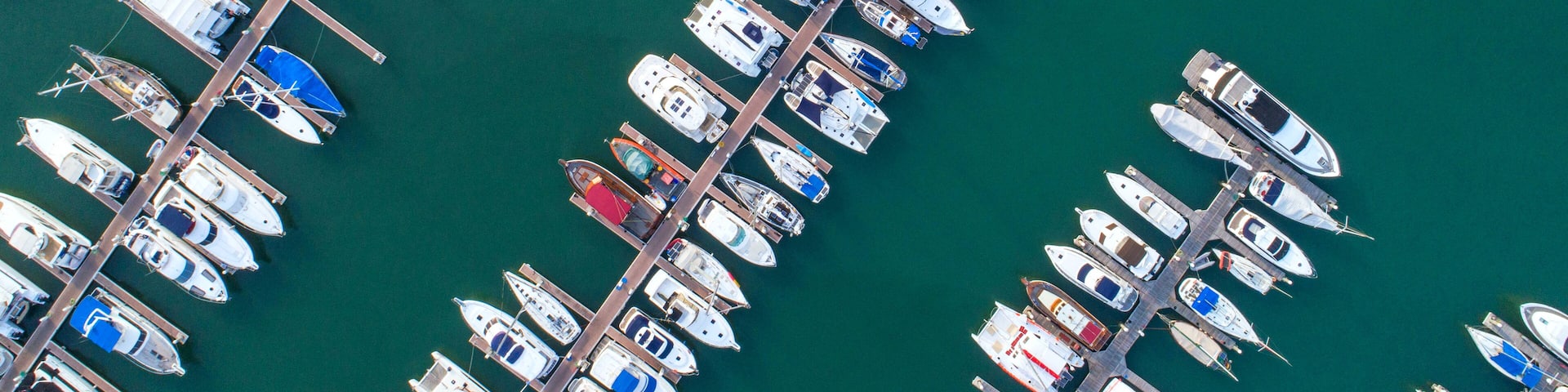 Pier speedboat. A marina lot. This is usually the most popular tourist attractions on the beach.Yacht and sailboat is moored at the quay.Aerial view by drone.Top view.