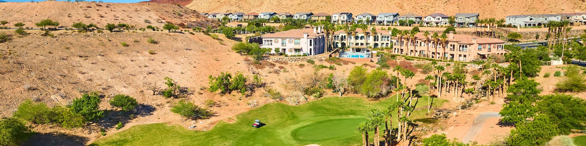 Aerial Golf Course Lush Fairway and Desert Oasis Community Fly Over