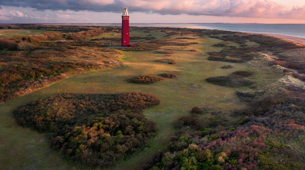Aerial view of Vuurtoren Westhoofd lighthouse along the coast at sunset, Ouddorp, The Netherlands.