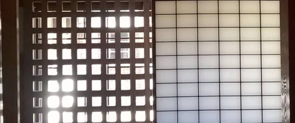 A traditional Japanese interior with tatami flooring, sliding doors, and shoji screens.
