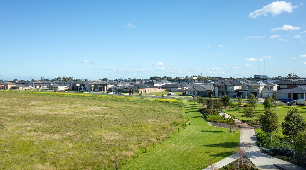 Aerial view of houses in the neighbourhood, and a large block of vacant land. A new suburb with many modern family homes in Point Cook, Melbourne VIC Australia. Copy space for your design.
