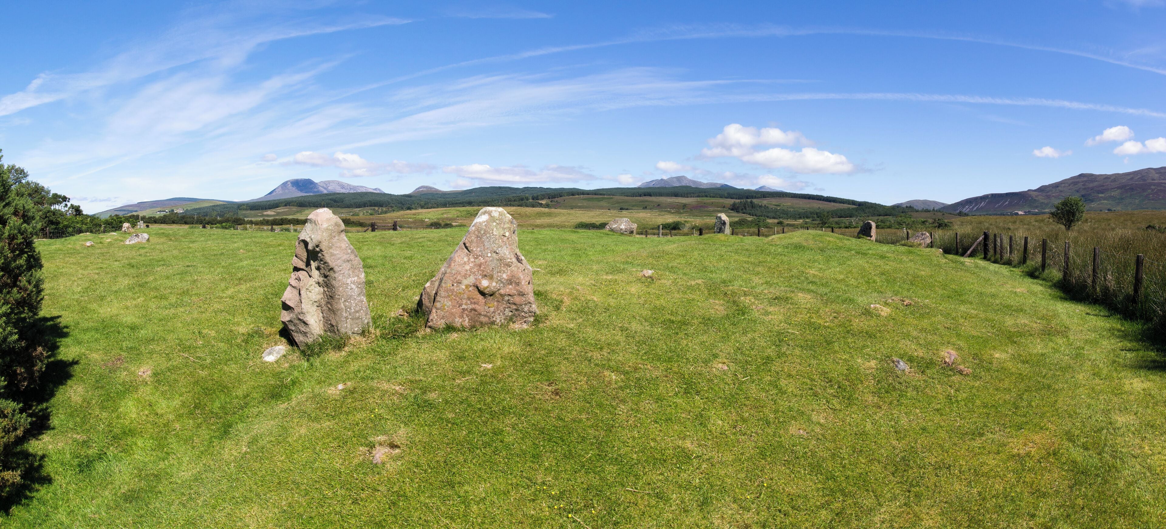 Stone Circle, Moss Farm Road, Arran. A cairn surrounded by a stone circle of 22m diameter.