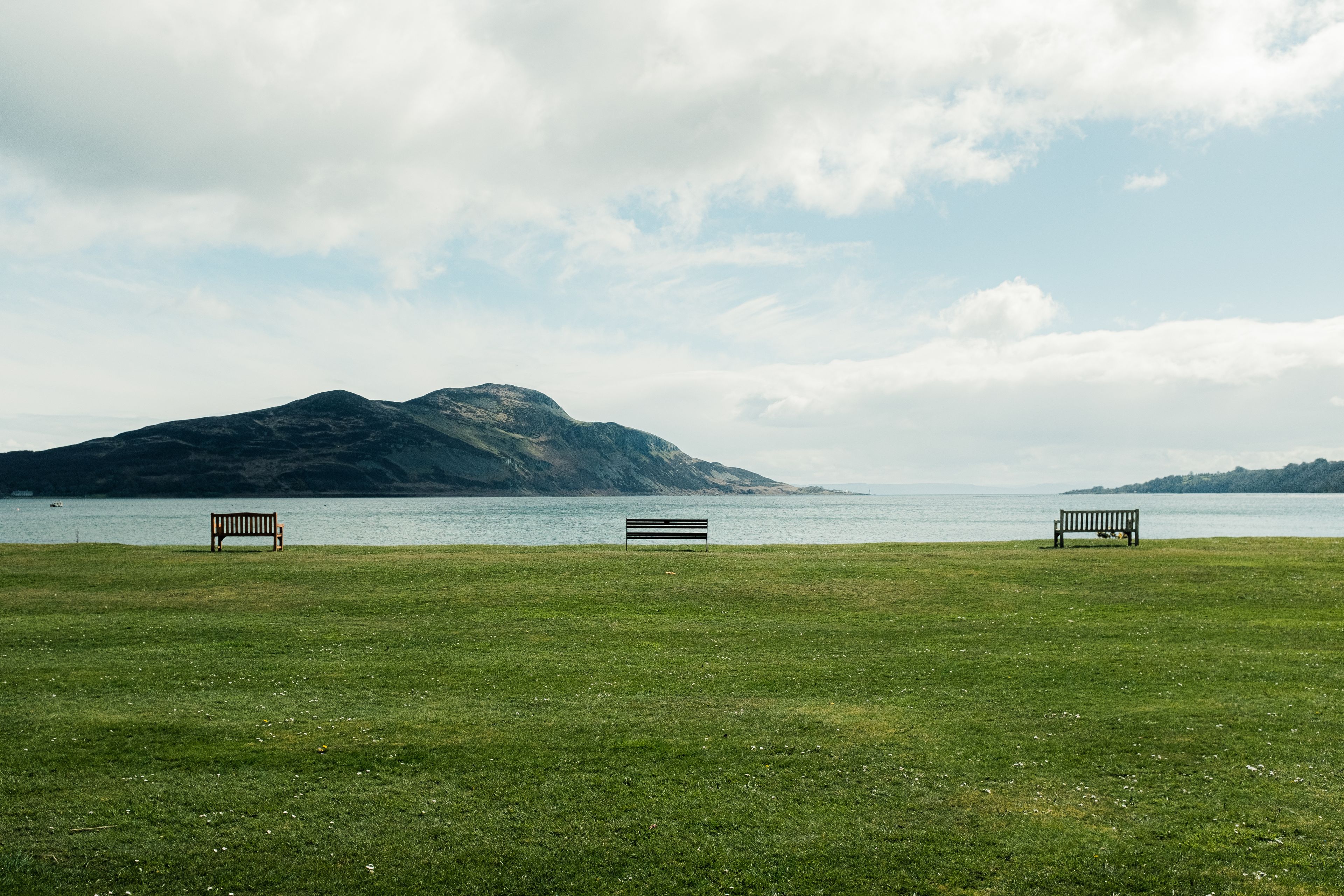 Benches overlooking Holy Isle off the coast of Lamlash on the Isle of Arran in Scotland.