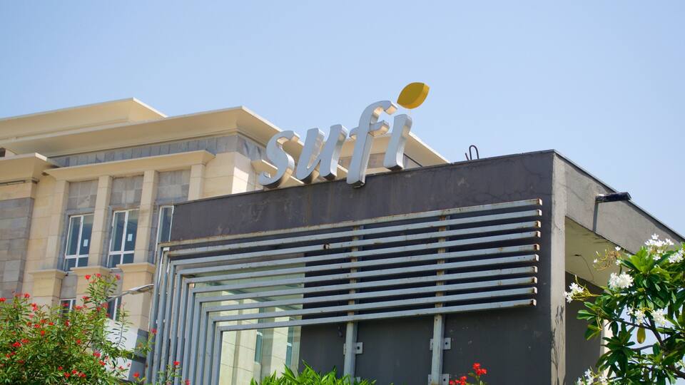 A building with a large sign reading "SMFI" and a modern architectural design.