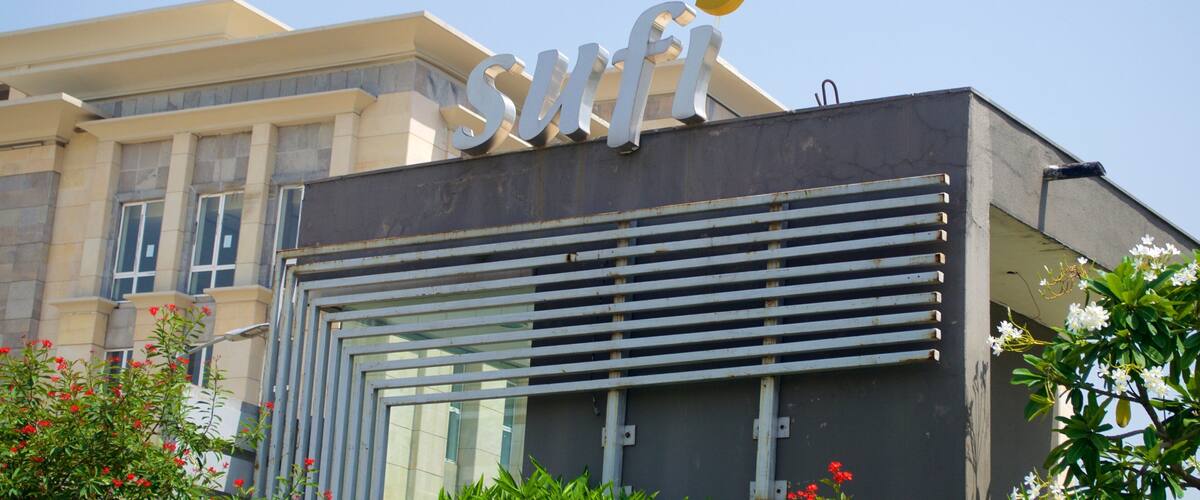 A building with a large sign reading "SMFI" and a modern architectural design.