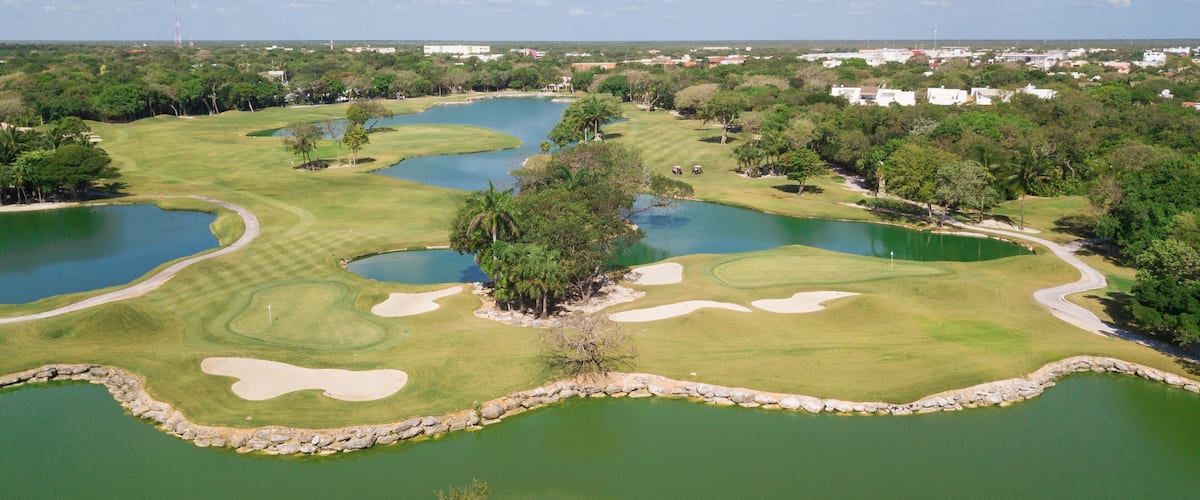 Golf course with gorgeous green and pond. Aerial view of a beautiful green golf course