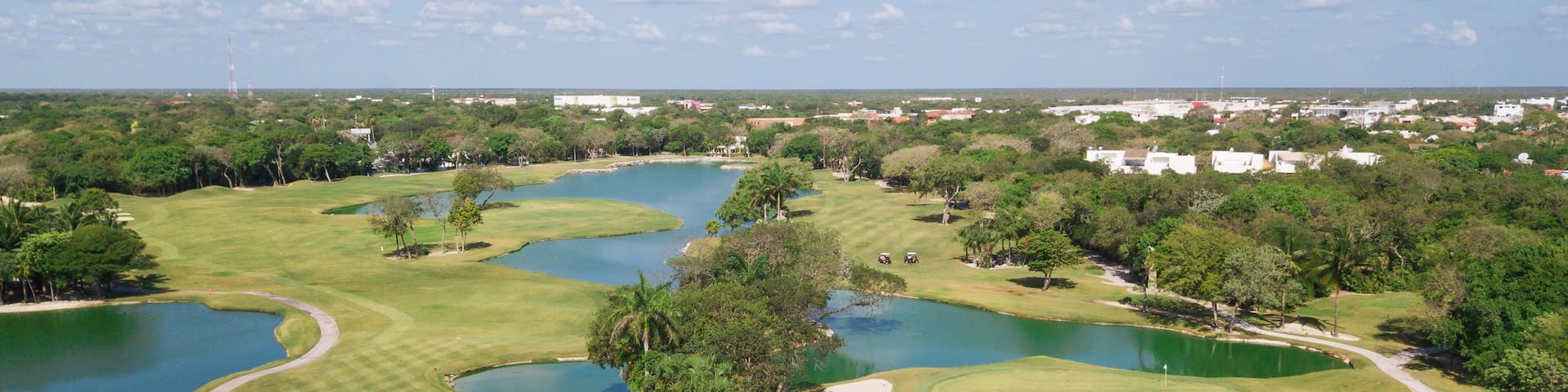 Golf course with gorgeous green and pond. Aerial view of a beautiful green golf course